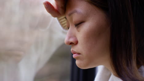 Close-Up-Of-Stressed-Or-Anxious-Woman-Suffering-With-Depression-Anxiety-Loneliness-Or-Agoraphobia-Leaning-Against-Window-At-Home-5