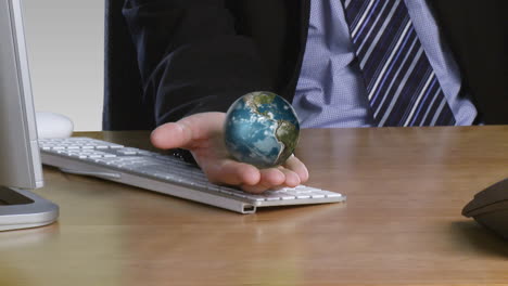 businessman with a rotary globe on his open hand