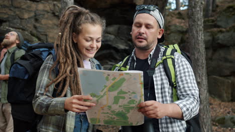 Hikers looking at a map in the woods