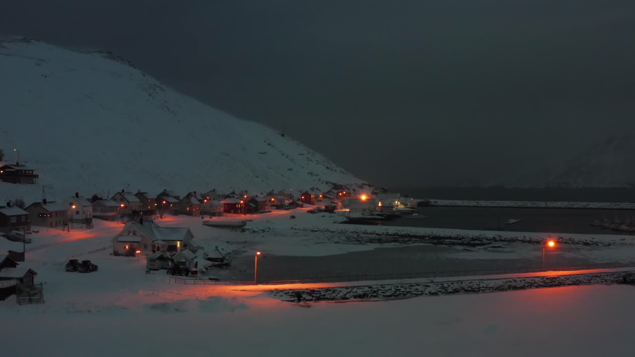 Moments before the snow storm hits the small village of Skarsvåg in Northern Norway. Aerial shot low to high angle