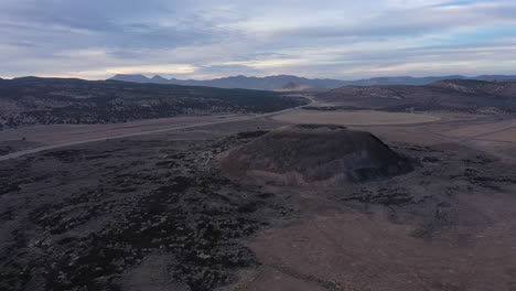 Drone-flying-towards-Veyo-Volcano-cinder-cone-in-Utah,-USA