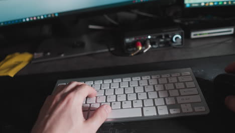 pov of a person multitasking on a computer, typing, and mousing with a contemplative glance away, as the screen changes