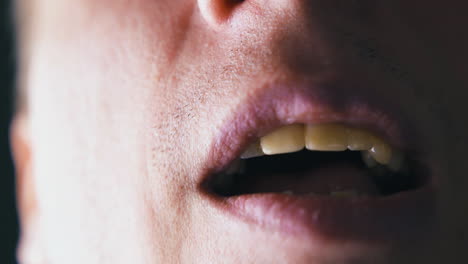 strange man moves lips and touches tooth with tongue macro