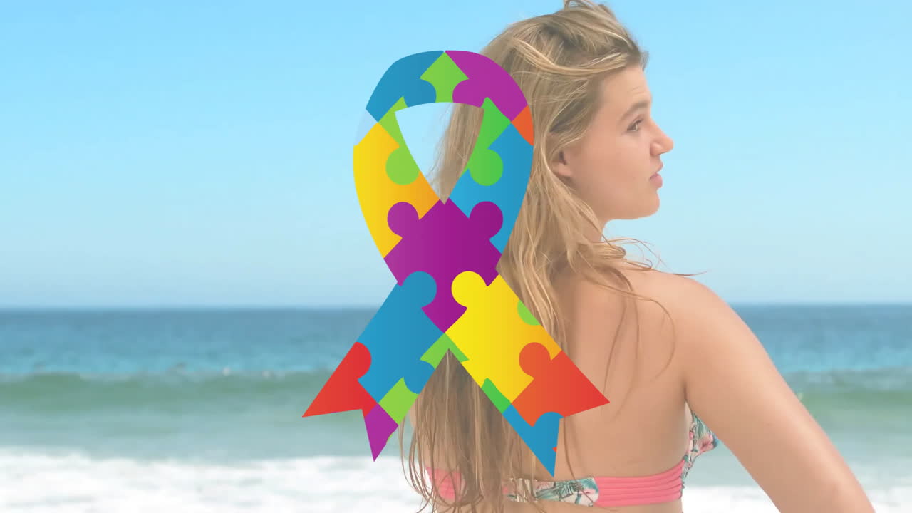 Colorful puzzle piece ribbon animation over woman standing by ocean