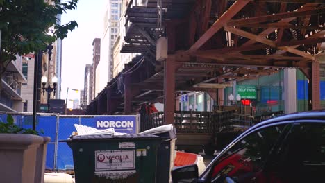 urban street scene with an elevated train track structure