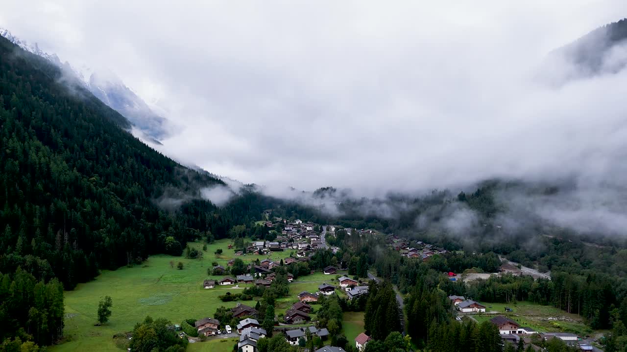 High resolution 4k drone aerial video of the beautiful town of Argentiere France an integral part of the famous TMB- Tour du Mont Blanc trail during a foggy peaceful morning in the month of September