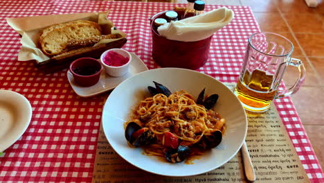 greek seafood pasta in a restaurant. zoom in shot