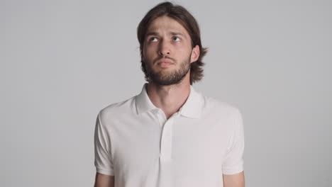 caucasian man in front of camera on gray background.