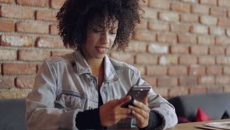 laughing woman with smartphone inside