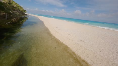 Fpv-Flight-over-tropical-sandy-beach-and-crystal-clear-Caribbean-Sea-in-Barahona,-Dominican-Republic