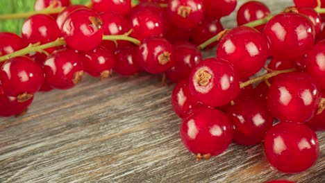 super close macro of a redcurrants on a wooden table.