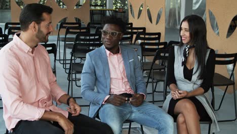 Group-of-young-workers-talking-in-office