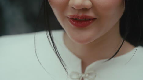 close-up of a woman's face with red lipstick