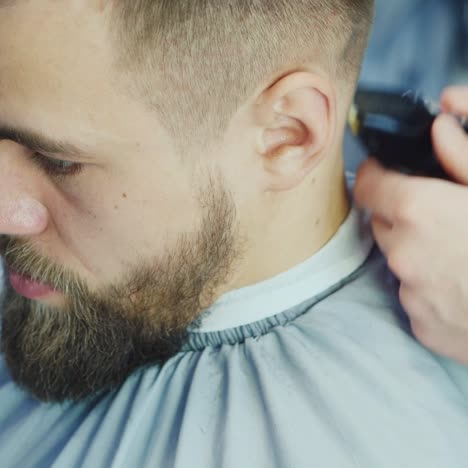 close up of barber working on client's hair and beard 03