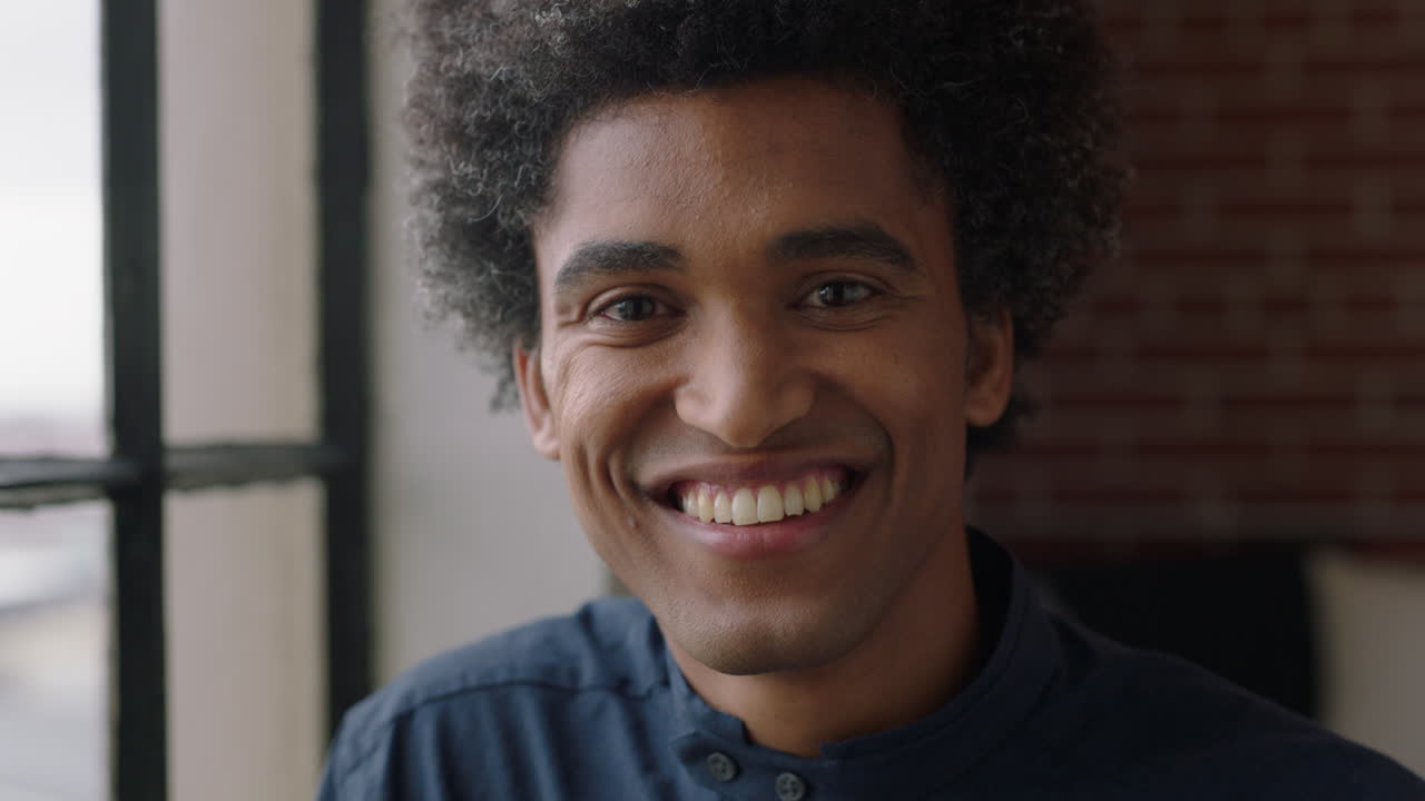 portrait happy mixed race man smiling enjoying lifestyle relaxing at home funky afro hairstyle