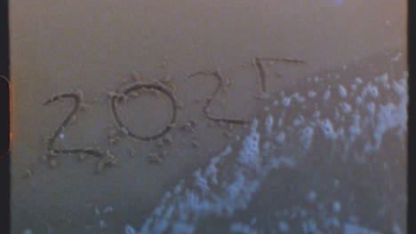 2024 and 2025 written in the sand on a beach