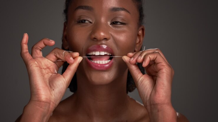 Woman flossing her teeth
