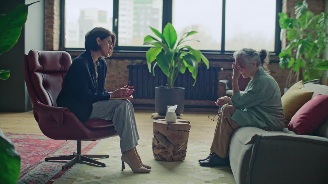 Female Therapist Talking to Stressed Elderly Woman on Counseling Session