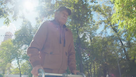 elderly man using walker in the park