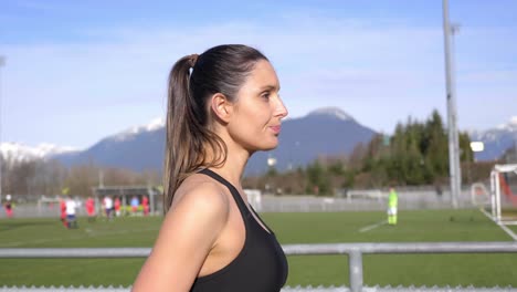 attractive young athletic woman drinking water after run slow motion