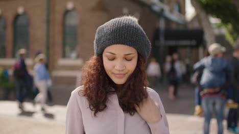 portrait of pretty mixed race girl looking lonely unhappy feeling shy wearing beanie hat urban background