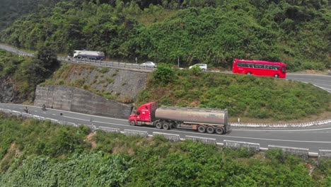 big truck is driving on hai van pass mountain road at vietnam, aerial