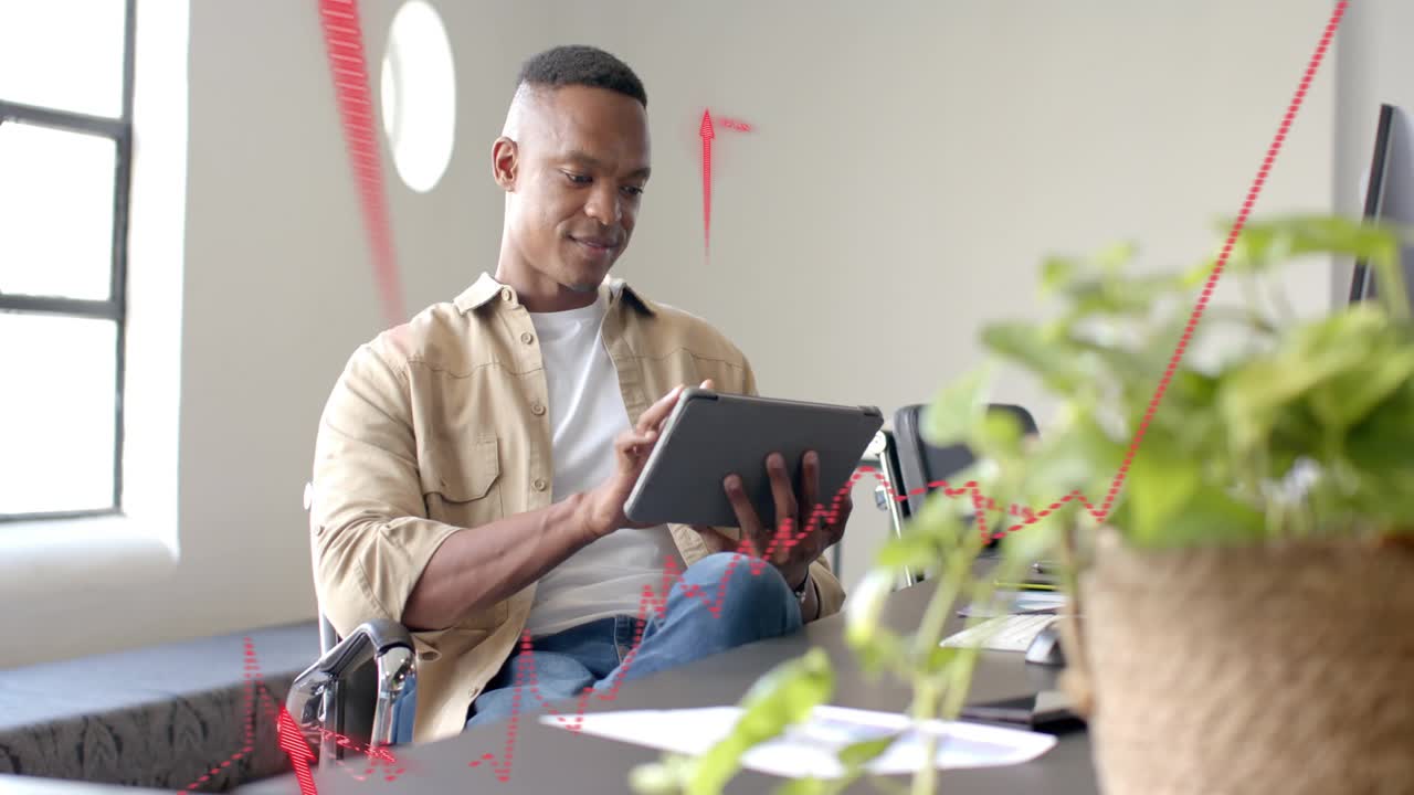Mid adult man tapping tablet, activating red finance charts and arrows while reviewing data