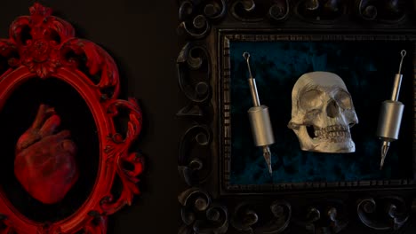 close-up of framed red heart and skull with syringes at artistic tattoo studio