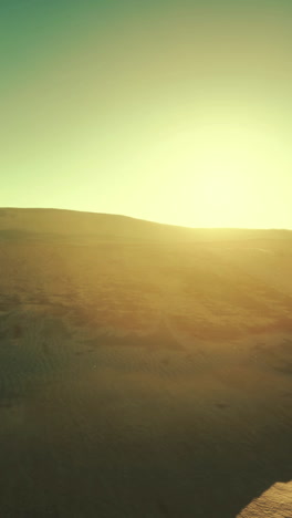 sunset over desert sand dunes