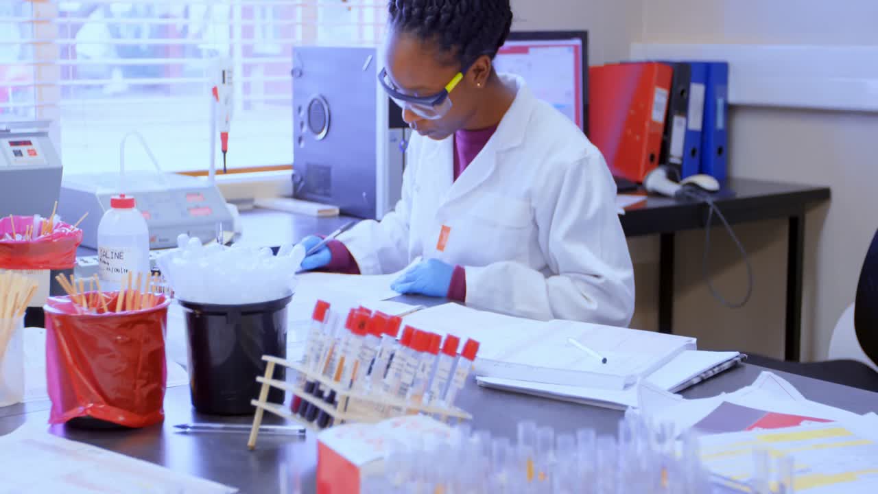 Laboratory technician checking invoices 4k