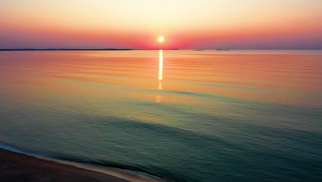 Sunrise-Colors-Reflect-off-Ocean-Waves-Overlooking-Beach-Houses