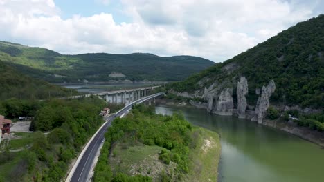 drone toward bridges crossing tsonevo reservoir next to striking rock formations