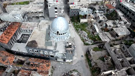 aerial view over ravaged mosque after bombing