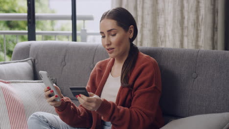 Woman-cheering-while-online-shopping-for-bargains