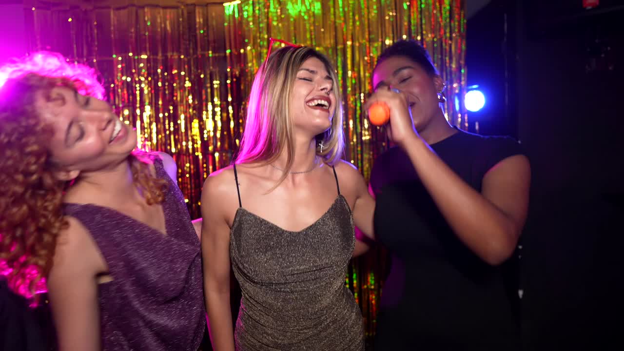 Women Enjoying Karaoke Night at a Party