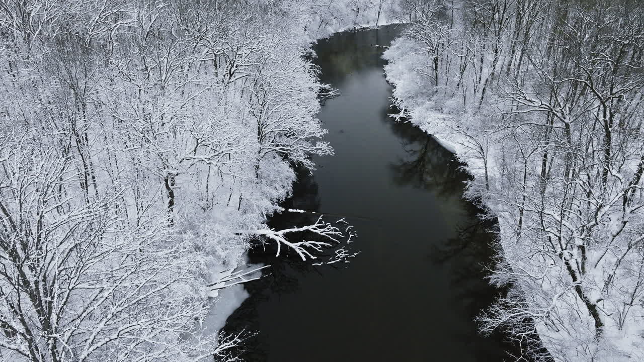 A drone's-eye journey above the snow-covered Huron River Valley, capturing its tranquil allure
