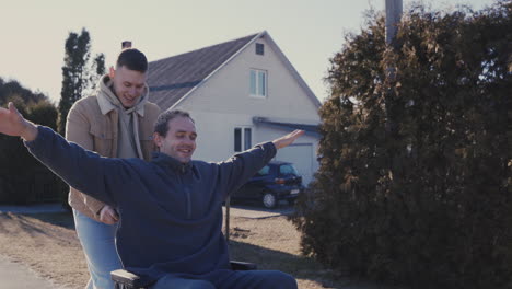 young man running while pushing his disabled friend in wheelchair and having fun together 1