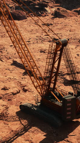 a large construction crane on a dirt construction site