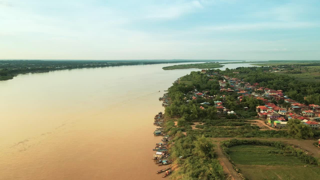 Drone lift over fishing village on the banks of the mighty Mekong river