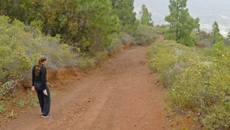 ocean reveal: brunette trekker descends tenerife's trails