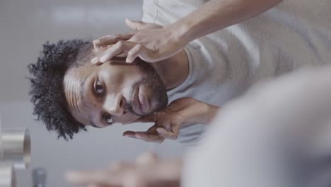 man's skincare routine in the bathroom