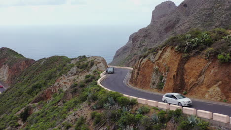 cars driving on road through mountains on the atlantic coast,canary islands,spain