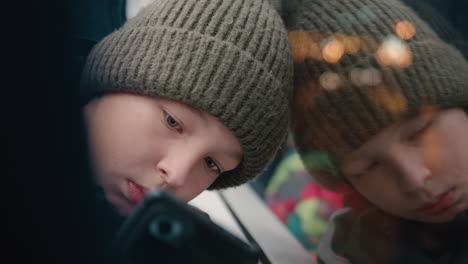 Teenage-boy-using-smartphone-during-bus-ride