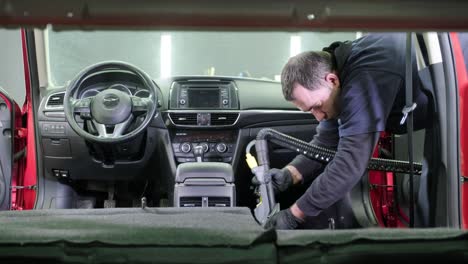 professional car cleaning. сar wash. interior detailing. dry clean and detail a car interior. deep seats cleaning. wiping foam in car wash. cleaning the car panel from dust. a vacuum cleaner