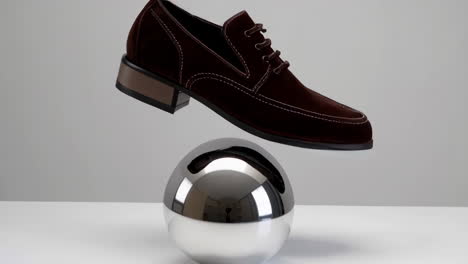 elegant brown velvet shoe on reflective sphere