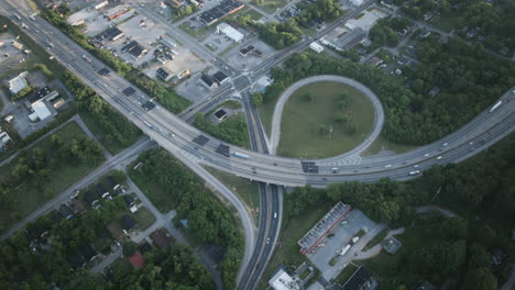 rotating aerial hyperlapse of an exit of the highway i-24 in chattanooga, tn with high traffic