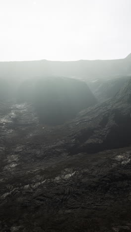 black mountains in deep fog