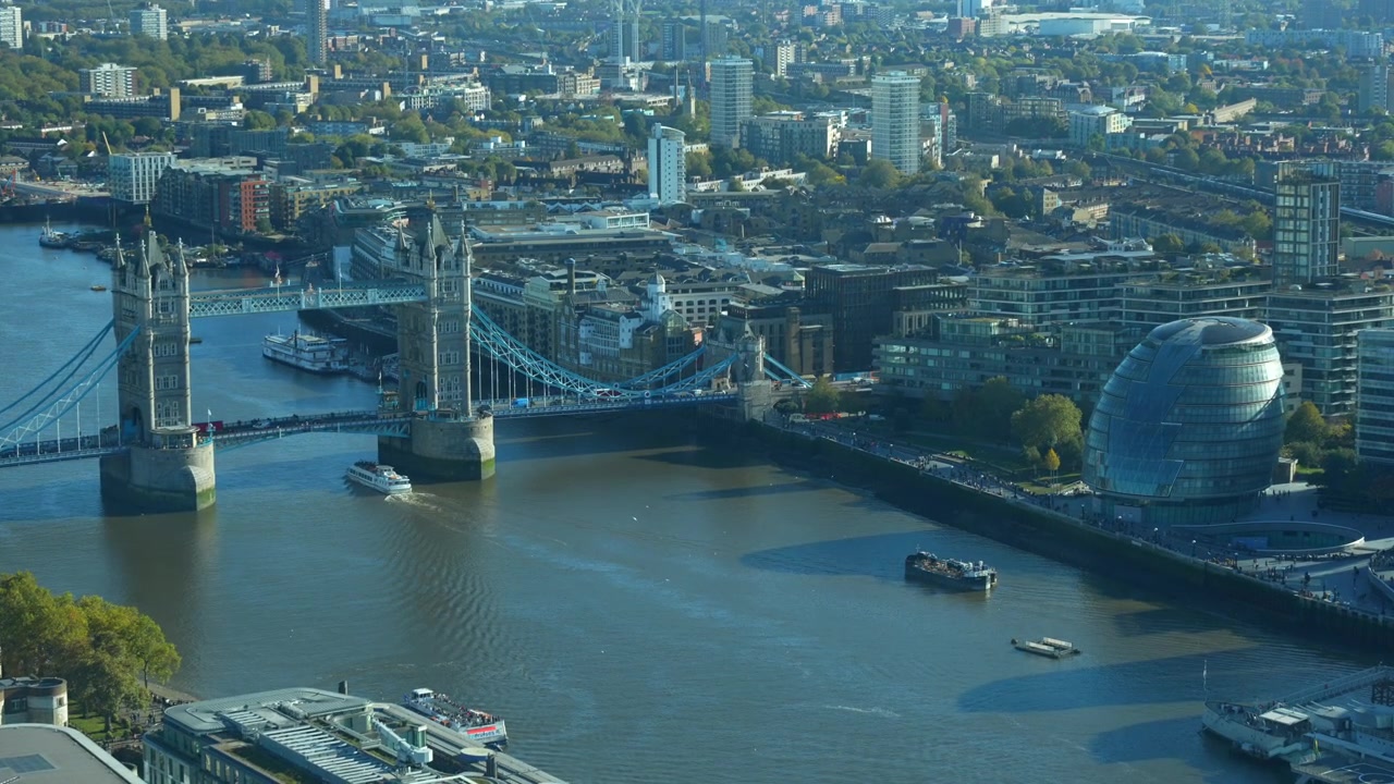 Boat crossing under Tower Bridge in Thames River. View from a window