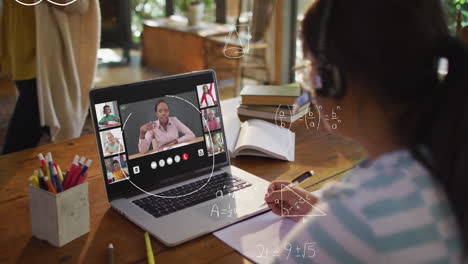 animation of mathematical equations over asian girl having a video conference on laptop at home