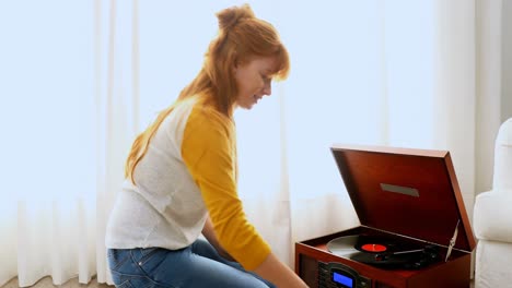 Beautiful-woman-listening-music-on-turntable-4k